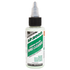 Small clear 2oz bottle of green Slip 2000 Carbon Killer with a white and green label