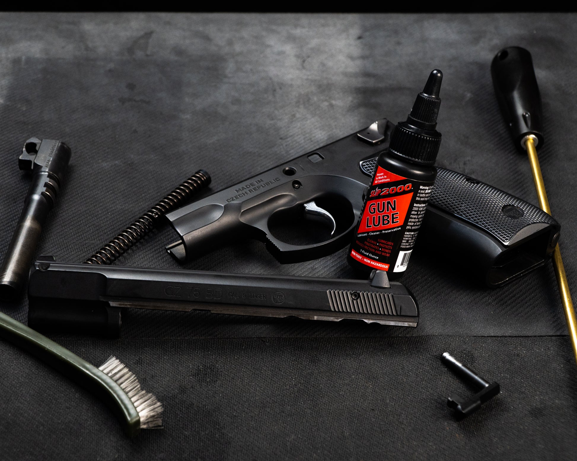 Red Slip 2000 Gun Lube sitting with a disassembled CZ 75