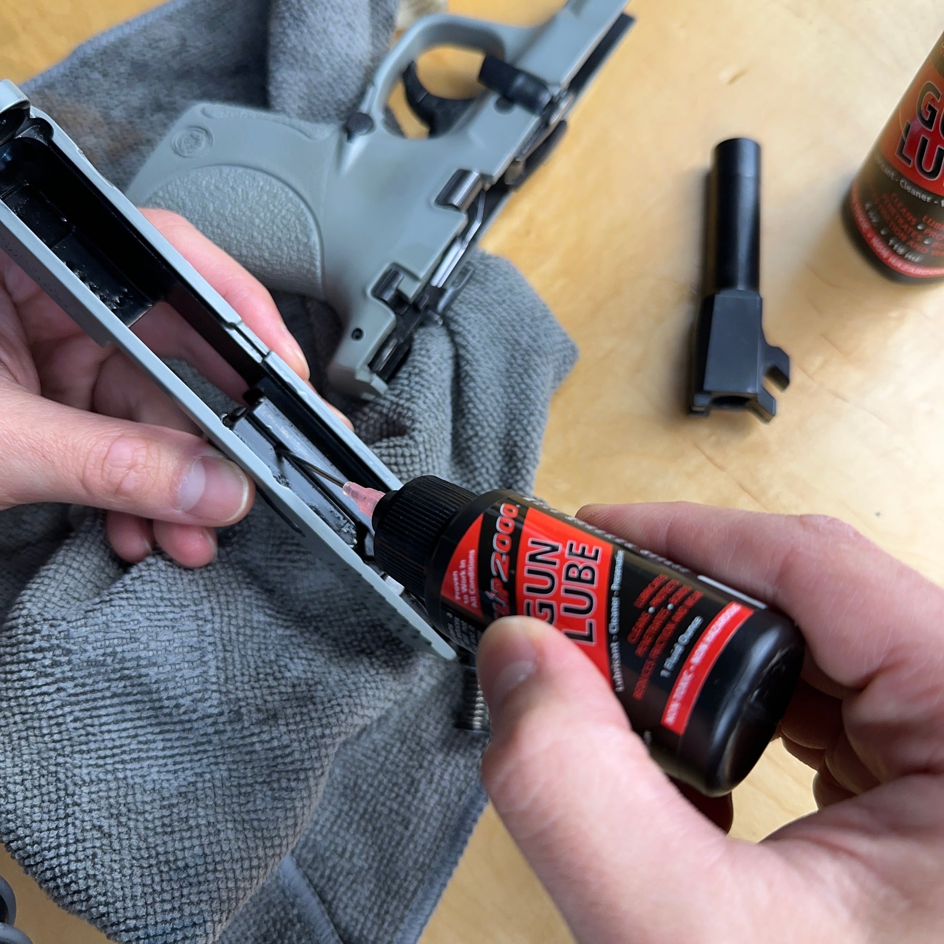 Red Slip 2000 Gun Lube applied to a pistol slide with a precision metal needle applicator