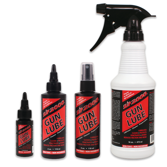 A set of Slip 2000 Gun Lube products including a spray bottle, two smaller bottles, and a bottle with a black cap.